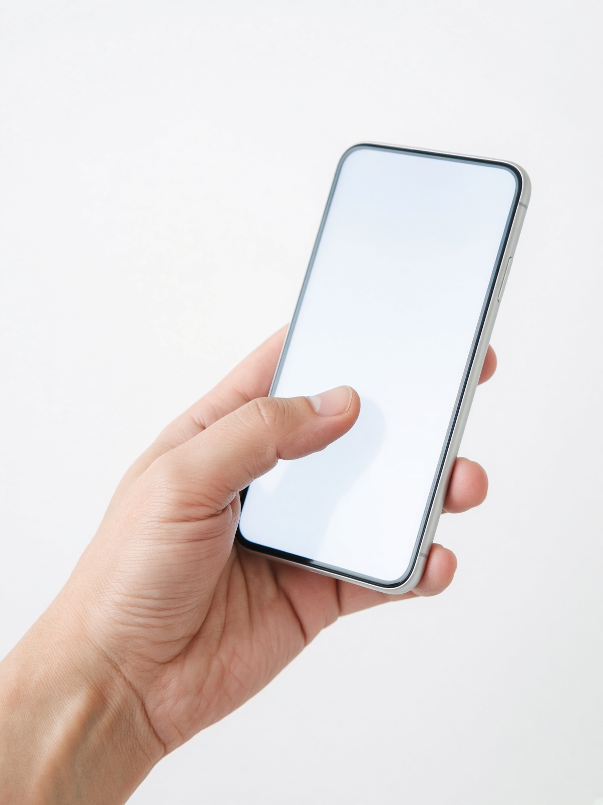 A hand holding a smartphone, no face in frame