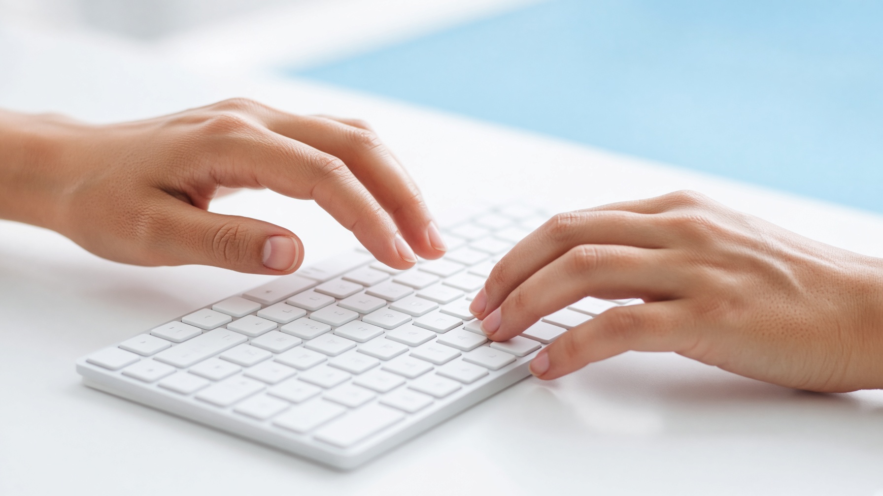 Hands resting on a backlit keyboard
